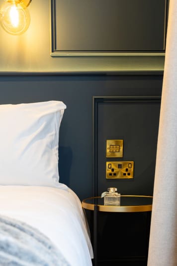 A neatly made bed with white sheets