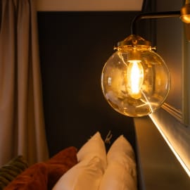 A light bulb illuminates a bedroom wall