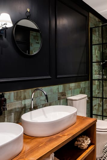 A modern bathroom featuring two sinks and a toilet
