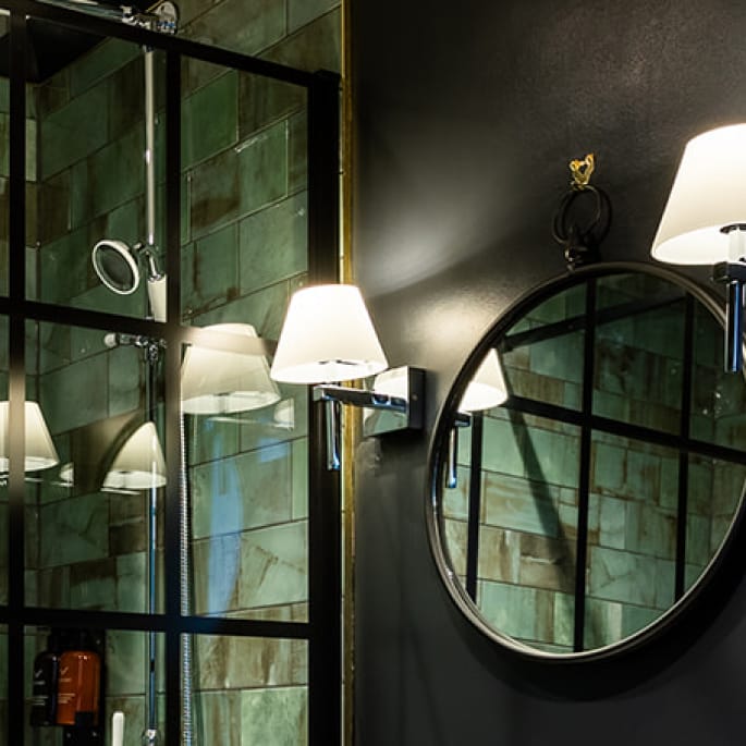 A modern bathroom featuring a round mirror