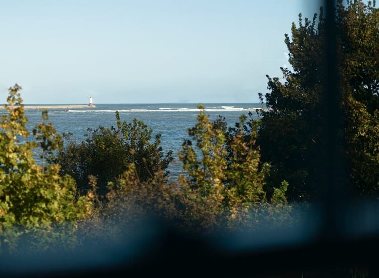 A serene view of the ocean visible through a large window