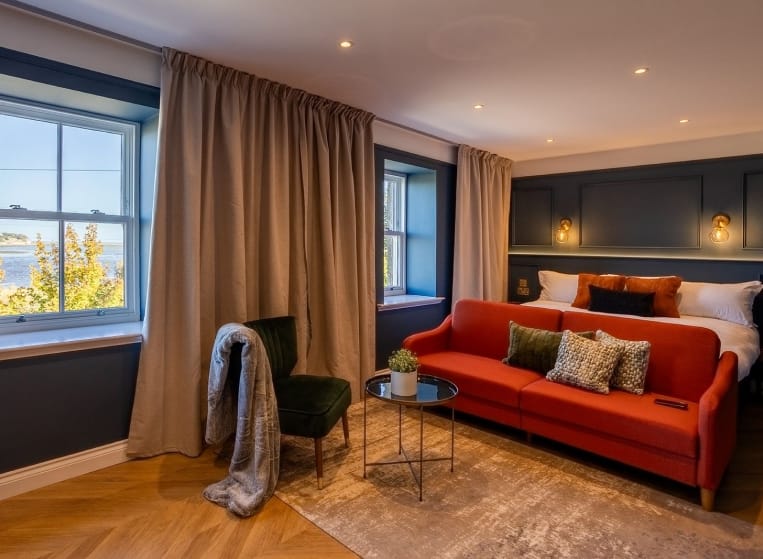 A cozy room featuring a vibrant red couch
