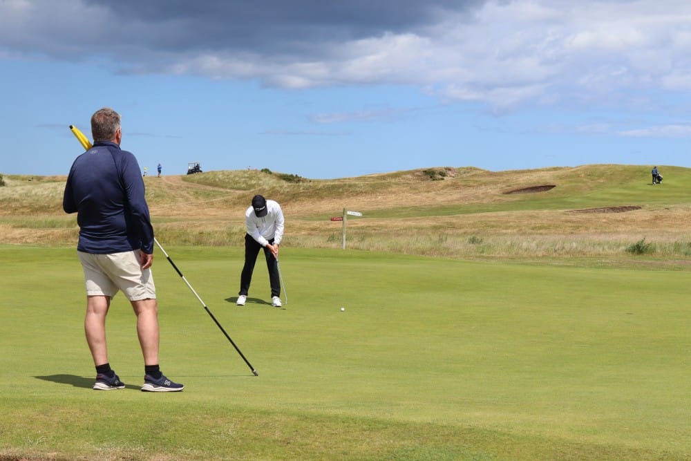 A black staircase leads to a blue chair